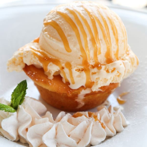 Lulu California Bistro's dessert: a golden cake topped with vanilla ice cream, caramel, whipped cream, and mint.